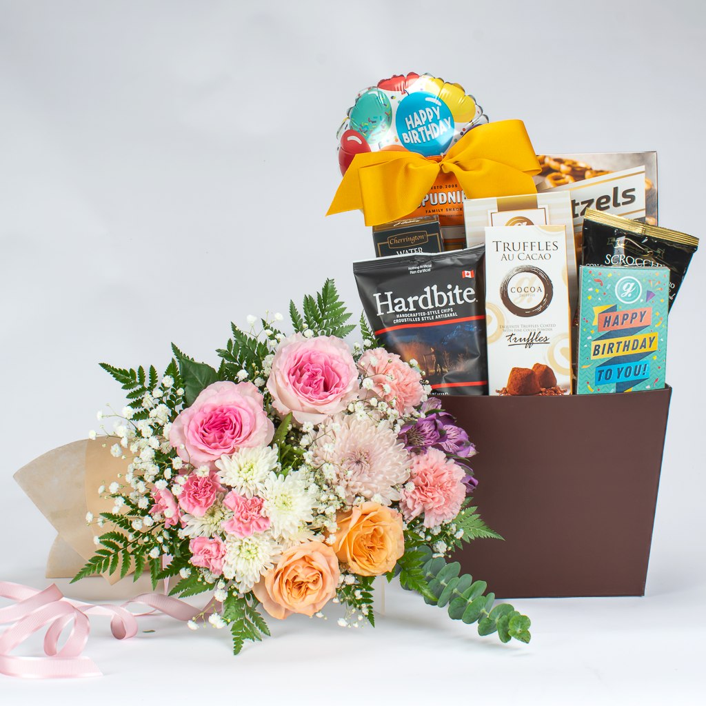 Themed birthday gift basket with a festive birthday wrapped chocolate gift and other sweet treats for a celebration.