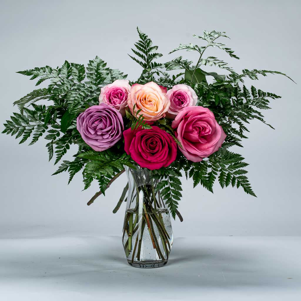 Glass vase with assorted 6 mix roses and greenery