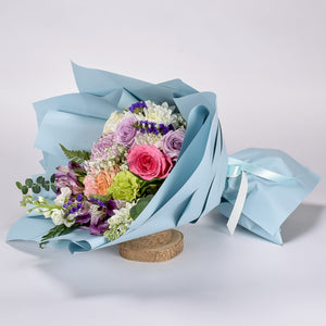 Vibrant Fresh Flowers Hand Wrapped In Baby Blue Floral Paper For Birthdays, Graduations, Celebrations And Just Because