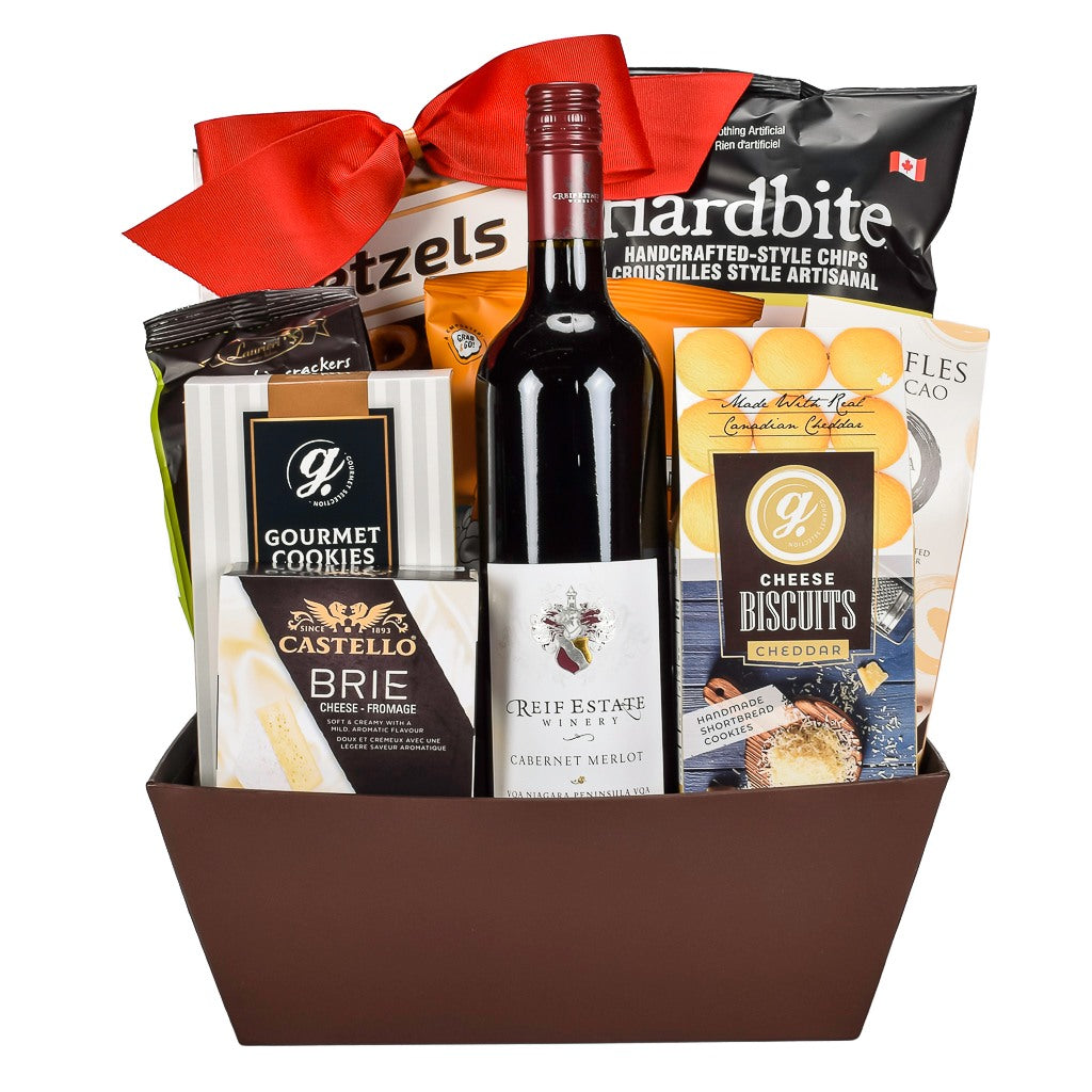 Rectangular Brown Gift Basket With Ontario Made Cabernet Wine, Cheddar Cookies, Chocolate Truffles, Castello Brie Cheese, Caramel Popcorn And Crispy Potato Chips Topped With A Big Red Bow