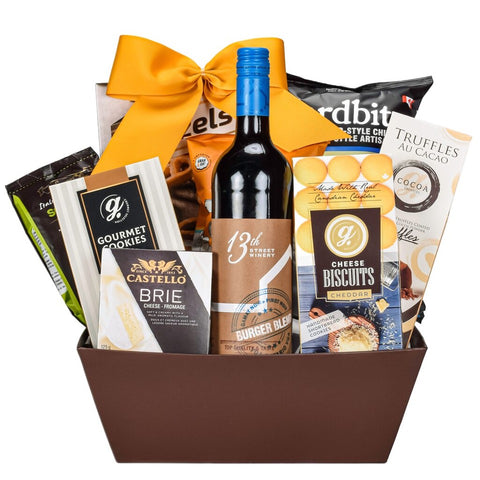 Rectangular Brown Gift Basket With Ontario Made Cabernet Wine, Cheddar Cookies, Chocolate Truffles, Castello Brie Cheese, Caramel Popcorn And Crispy Potato Chips Topped With a Gold Bow