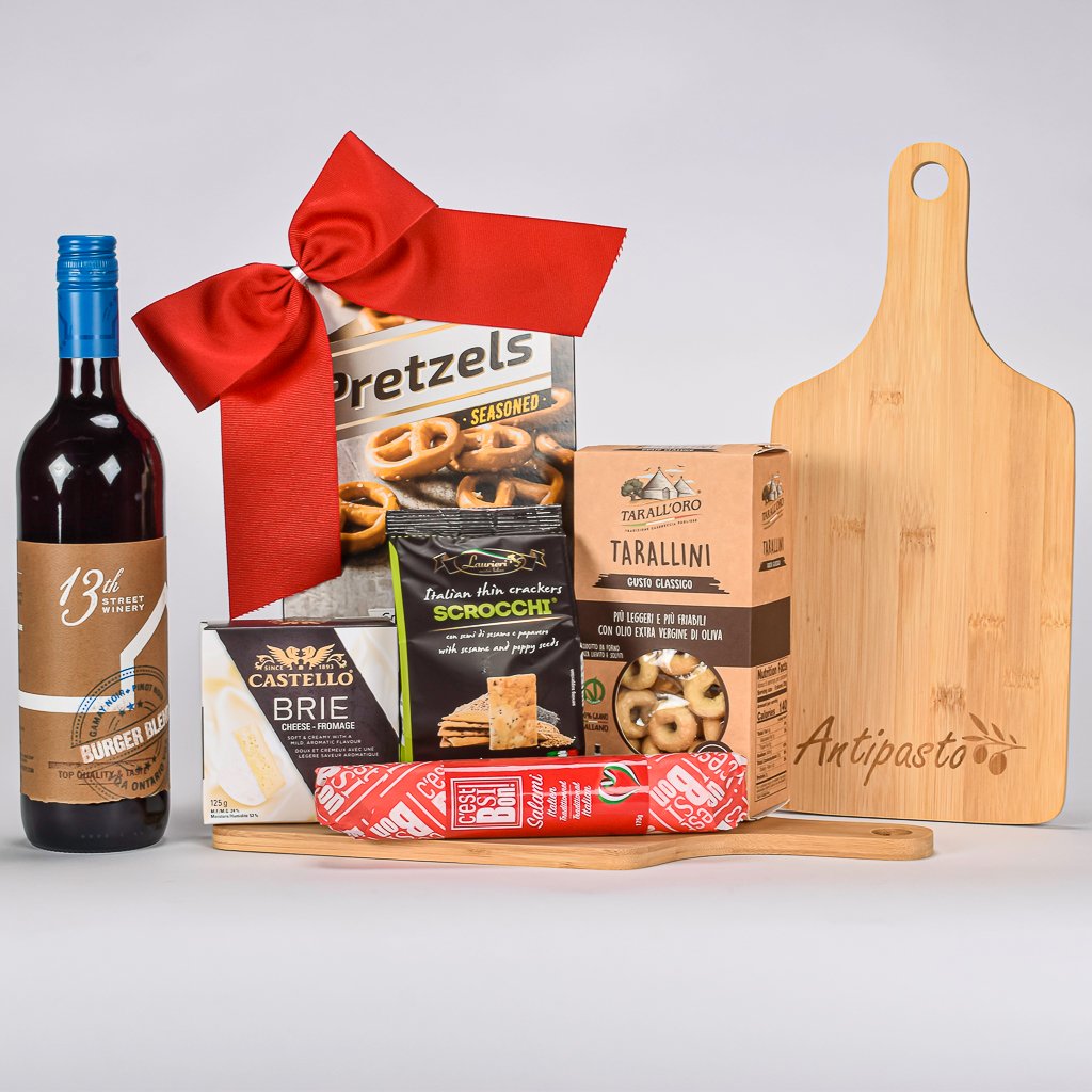 Red Canadian WIne With Crackers, Cheese, Pretzels, Salami And Tarallini On An Antipasto Engraved Board