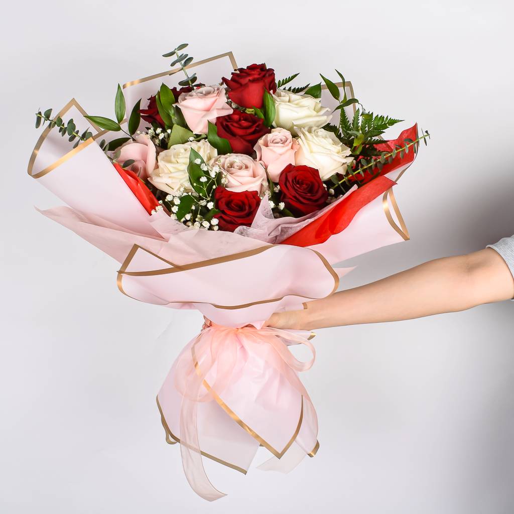 A Dozen Red, Pink And Whtie Roses Wrapped In Korean Pink Paper