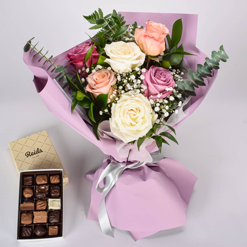 6 Mixed Coloured Roses Wrapped In Purple Korean Style Paper With Reids Assorted Chocolate