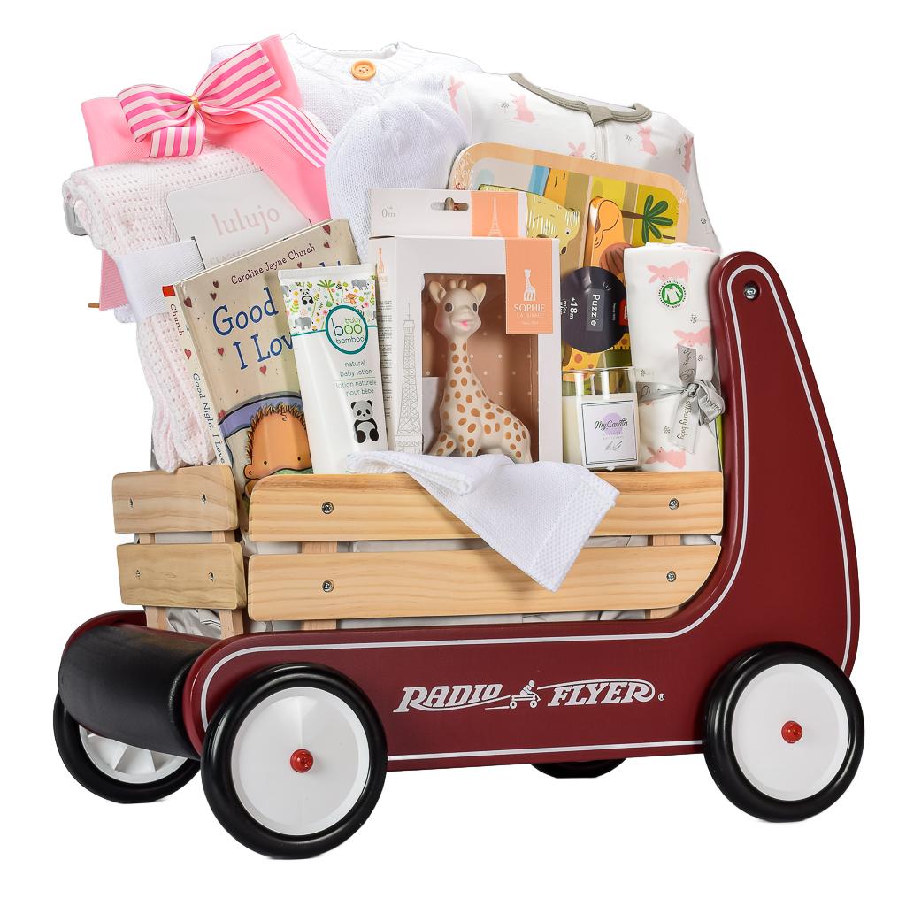 Red Radio Flyer Wagon With Sophie The Giraffe Teether, Organice Onesie, Pink Knit Blanket, Baby Book, And Animal Puzzle For Baby Girl