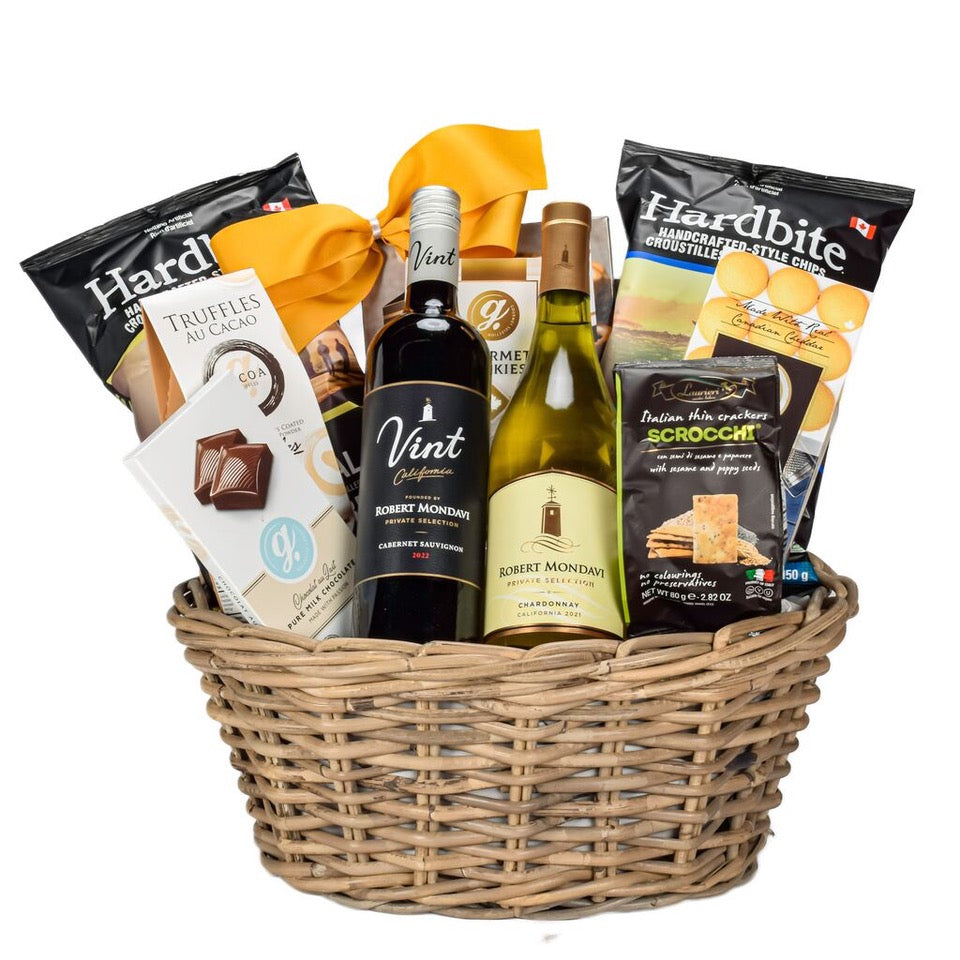 Premium Mondavi Cabernet And Chardonnay With Chips, Cookies, Chocolate, Crackers, And Pretzles In A Brown Oval Basket 