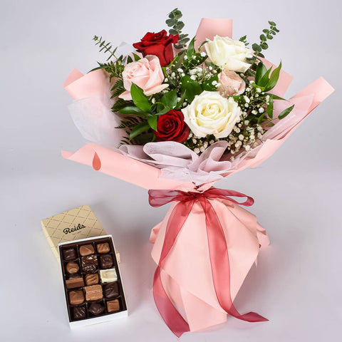 White, Pink And Red Roses Wrapped In Pink Korean Paper With A Box of Assorted Chocolates