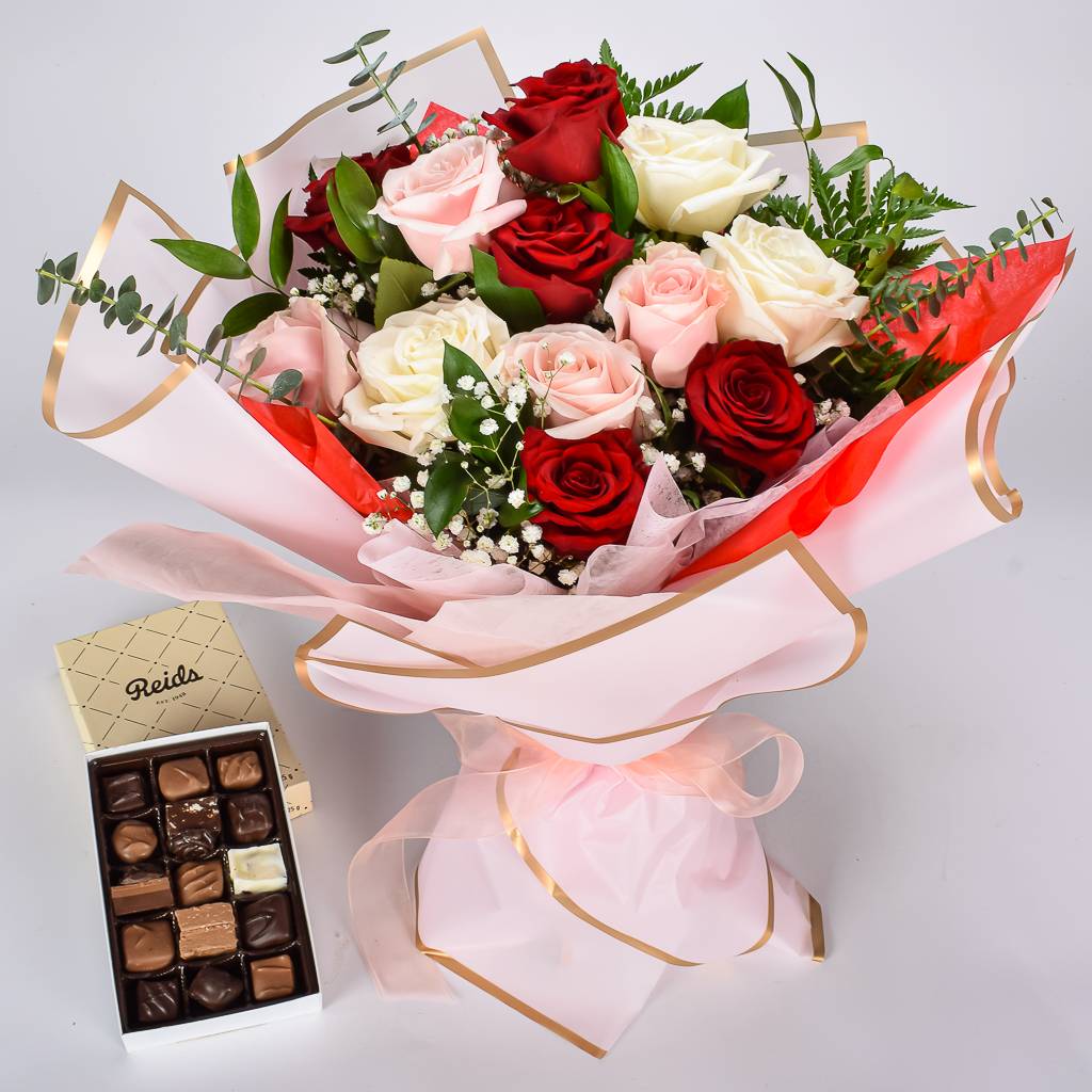 A Dozen Roses Bouquet Wrapped In Premium Korean Paper With A Reids Assorted Chocolate Box 