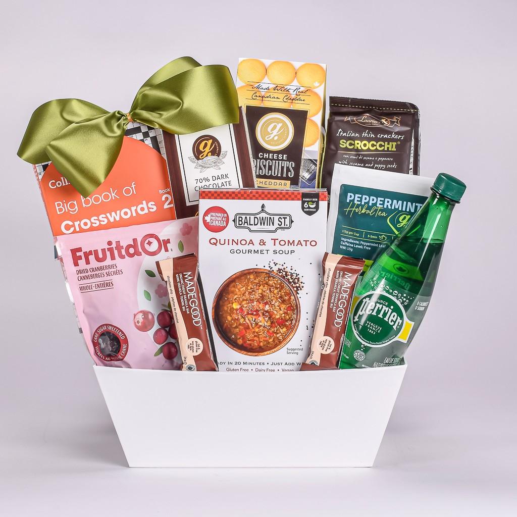 White Get Well Gift Basket With Soup, Granola Bars, Peppermint Tea, Sparkling Water, Crossword Puzzles, And Biscuits