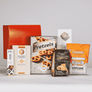 Assorted snack products including pretzels, cookies, and popcorn on a white background