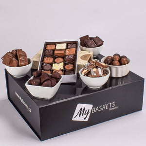 Milk, Dark, And White Chocolates, Truffles, And Nut Bar In A Black Gift Box
